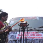 A protester lights a ceremonial lamp at a rally organized by the Association of Relatives of the Enforced Disappeared in the North and East, held in Jaffna on 30 August 2026 as part of the “Long Road to Justice” conference marking the International Day of the Disappeared. Image courtesy of Kumara Kana.
