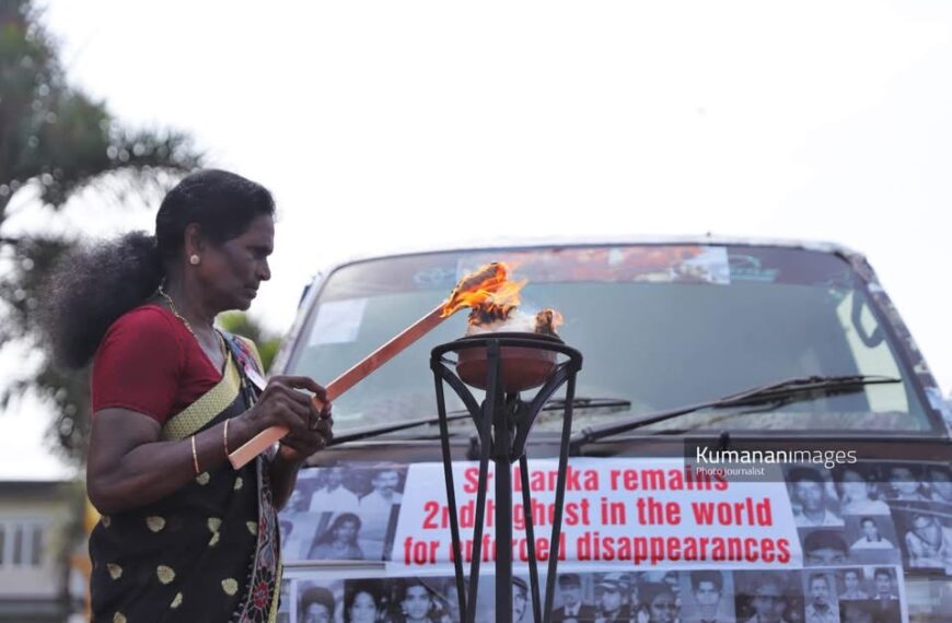 A protester lights a ceremonial lamp at a rally organized by the Association of Relatives of the Enforced Disappeared in the North and East, held in Jaffna on 30 August 2026 as part of the “Long Road to Justice” conference marking the International Day of the Disappeared. Image courtesy of Kumara Kana.
